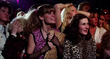 Movie still from “Rock 'n' Roll High School” (1979), directed by Joe Dante – A group of people that are standing in a room; Medium shot, High angle