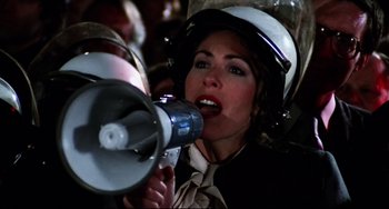 Movie still from “Rock 'n' Roll High School” (1979), directed by Joe Dante – A woman wearing a helmet is holding a megaphone; Close Up shot, Low angle