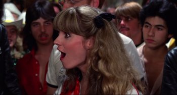 Movie still from “Rock 'n' Roll High School” (1979), directed by Joe Dante – A woman with a surprised look on her face; Close Up shot, Over the shoulder angle