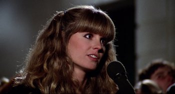 Movie still from “Rock 'n' Roll High School” (1979), directed by Joe Dante – A person holding a microphone; Close Up shot, Low angle