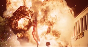 Movie still from “Rock 'n' Roll High School” (1979), directed by Joe Dante – An american flag is shown in front of a large explosion; Extreme Wide shot, Low angle