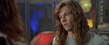 Movie still from “Rock Star” (2001), directed by Stephen Herek – A person with long red hair; Close Up shot, Over the shoulder angle