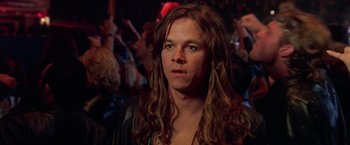 Movie still from “Rock Star” (2001), directed by Stephen Herek – A man with long brown hair wearing a leather jacket; Close Up shot, Over the shoulder angle