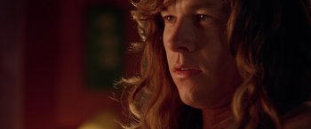 Movie still from “Rock Star” (2001), directed by Stephen Herek – A person with long hair; Close Up shot, Low angle