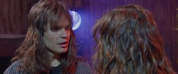 Movie still from “Rock Star” (2001), directed by Stephen Herek – A woman is looking at herself in the mirror; Close Up shot, Over the shoulder angle