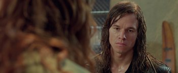 Movie still from “Rock Star” (2001), directed by Stephen Herek – A man with long hair looking into a mirror; Close Up shot, Over the shoulder angle