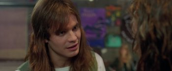 Movie still from “Rock Star” (2001), directed by Stephen Herek – A person with long brown hair; Close Up shot, Over the shoulder angle