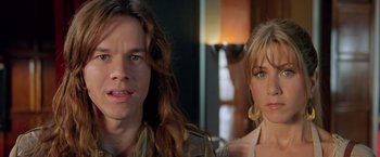 Movie still from “Rock Star” (2001), directed by Stephen Herek – A man and a woman standing next to each other in a room; Close Up shot, Over the shoulder angle