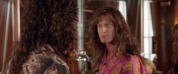 Movie still from “Rock Star” (2001), directed by Stephen Herek – A man with long brown hair stares at a woman; Close Up shot, Over the shoulder angle