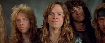 Movie still from “Rock Star” (2001), directed by Stephen Herek – A person with long brown hair; Close Up shot, Low angle