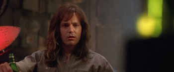 Movie still from “Rock Star” (2001), directed by Stephen Herek – A person with long brown hair; Close Up shot, Low angle