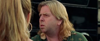 Movie still from “Rock Star” (2001), directed by Stephen Herek – A person with long blonde hair; Close Up shot, Over the shoulder angle