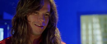 Movie still from “Rock Star” (2001), directed by Stephen Herek – A person with long brown hair; Close Up shot, Over the shoulder angle