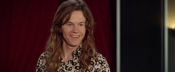 Movie still from “Rock Star” (2001), directed by Stephen Herek – A person with long hair; Close Up shot, High angle