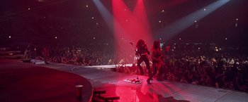 Movie still from “Rock Star” (2001), directed by Stephen Herek – A group of people that are on a stage; Wide shot, High angle