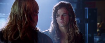 Movie still from “Rock Star” (2001), directed by Stephen Herek – A man with long hair is looking into a mirror; Close Up shot, Over the shoulder angle