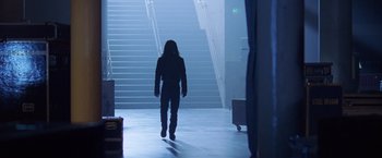 Movie still from “Rock Star” (2001), directed by Stephen Herek – A person walking down a set of stairs; Wide shot, Low angle