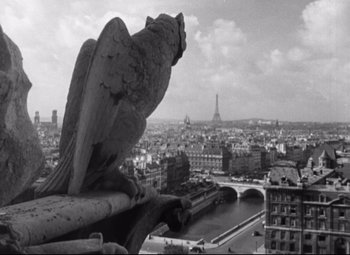 Movie still from “Roman Holiday” (1953), directed by William Wyler – A black - and - white photo of a bird sitting on top of a building; Wide shot, Low angle