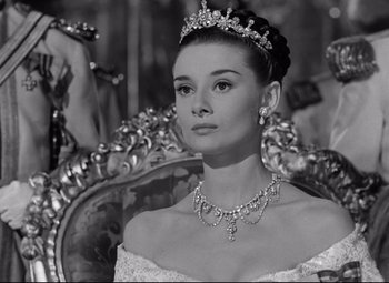 Movie still from “Roman Holiday” (1953), directed by William Wyler – A black - and - white photo of a woman wearing a tiara; Close Up shot, Low angle
