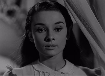 Movie still from “Roman Holiday” (1953), directed by William Wyler – A black - and - white photo of a young woman; Close Up shot, Low angle