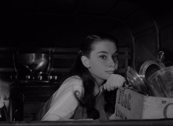Movie still from “Roman Holiday” (1953), directed by William Wyler – Black and white photograph of a woman in a kitchen; Close Up shot, Low angle