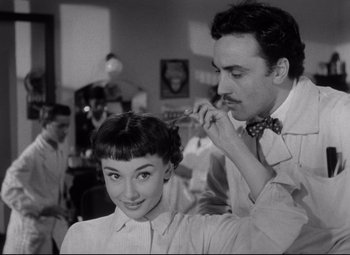 Movie still from “Roman Holiday” (1953), directed by William Wyler – An old black and white photo of a woman getting her hair cut; Close Up shot, Low angle