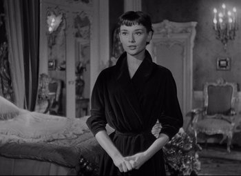 Movie still from “Roman Holiday” (1953), directed by William Wyler – A black and white photo of a woman in a robe; Medium shot, Over the shoulder angle