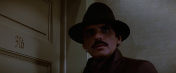 Movie still from “Romancing the Stone” (1984), directed by Robert Zemeckis – A person wearing a hat; Close Up shot, Low angle