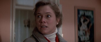 Movie still from “Romancing the Stone” (1984), directed by Robert Zemeckis – A person wearing a jacket; Close Up shot, Over the shoulder angle