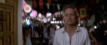 Movie still from “Romancing the Stone” (1984), directed by Robert Zemeckis – A person wearing a white shirt; Close Up shot, Over the shoulder angle