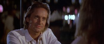 Movie still from “Romancing the Stone” (1984), directed by Robert Zemeckis – A person wearing a white shirt; Close Up shot, Low angle