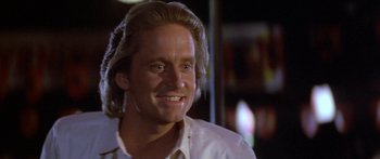 Movie still from “Romancing the Stone” (1984), directed by Robert Zemeckis – A person wearing a white shirt; Close Up shot, Low angle