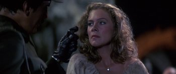 Movie still from “Romancing the Stone” (1984), directed by Robert Zemeckis – A person holding a hair brush; Close Up shot, Over the shoulder angle