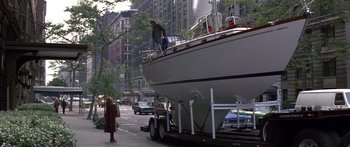 Movie still from “Romancing the Stone” (1984), directed by Robert Zemeckis – A man standing on the side of a boat on a trailer; Wide shot, High angle