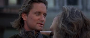 Movie still from “Romancing the Stone” (1984), directed by Robert Zemeckis – A person talking to another person; Close Up shot, Over the shoulder angle