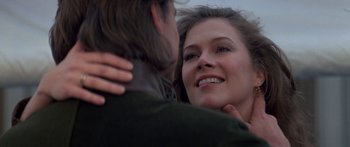 Movie still from “Romancing the Stone” (1984), directed by Robert Zemeckis – A person hugging another person; Close Up shot, Over the shoulder angle