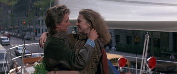 Movie still from “Romancing the Stone” (1984), directed by Robert Zemeckis – A man and a woman embracing each other; Medium shot, Over the shoulder angle