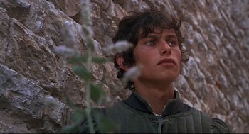 Movie still from “Romeo and Juliet” (1968), directed by Franco Zeffirelli – A young man standing in front of a stone wall; Close Up shot, Low angle