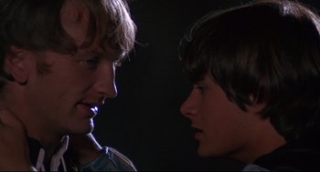 Movie still from “Romeo and Juliet” (1968), directed by Franco Zeffirelli – Two young men face each other in the dark; Close Up shot, Over the shoulder angle