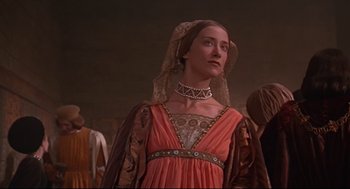 Movie still from “Romeo and Juliet” (1968), directed by Franco Zeffirelli – A woman in a red dress wearing a veil; Medium shot, Low angle
