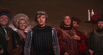 Movie still from “Romeo and Juliet” (1968), directed by Franco Zeffirelli – A group of people standing next to each other wearing costumes; Medium shot, Low angle