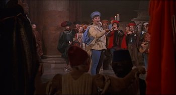 Movie still from “Romeo and Juliet” (1968), directed by Franco Zeffirelli – A group of people standing in a room; Wide shot, High angle