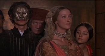 Movie still from “Romeo and Juliet” (1968), directed by Franco Zeffirelli – A group of people standing next to each other; Medium shot, Over the shoulder angle