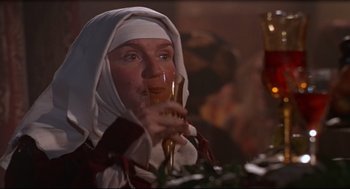Movie still from “Romeo and Juliet” (1968), directed by Franco Zeffirelli – A woman wearing a nun's outfit holding a glass of wine; Close Up shot, Low angle