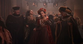 Movie still from “Romeo and Juliet” (1968), directed by Franco Zeffirelli – A group of people dressed in medieval clothing; Wide shot, High angle