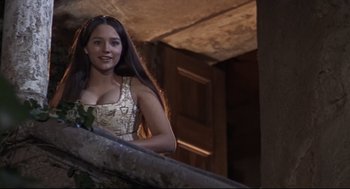 Movie still from “Romeo and Juliet” (1968), directed by Franco Zeffirelli – A beautiful young lady standing on top of a staircase; Medium shot, High angle