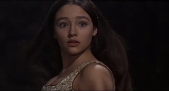 Movie still from “Romeo and Juliet” (1968), directed by Franco Zeffirelli – A woman with long black hair is looking at the camera; Close Up shot, High angle