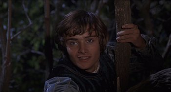 Movie still from “Romeo and Juliet” (1968), directed by Franco Zeffirelli – A young man holding a wooden stick in the woods; Close Up shot, High angle