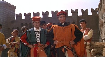 Movie still from “Romeo and Juliet” (1968), directed by Franco Zeffirelli – A group of men standing next to each other in medieval costumes; Medium shot, High angle