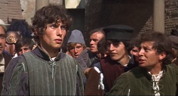 Movie still from “Romeo and Juliet” (1968), directed by Franco Zeffirelli – A group of people standing around each other; Medium shot, High angle